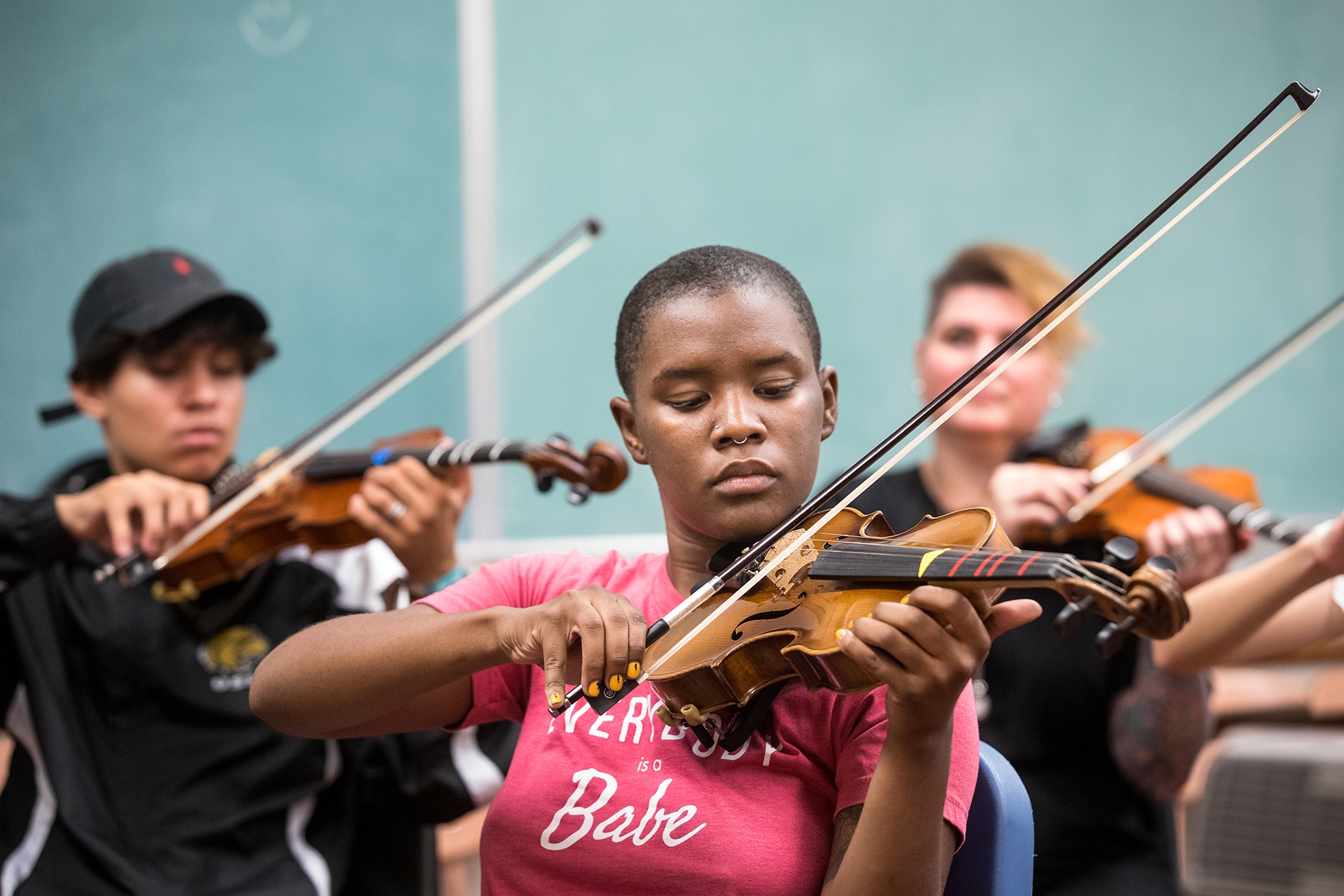 students take their first lesson in violin