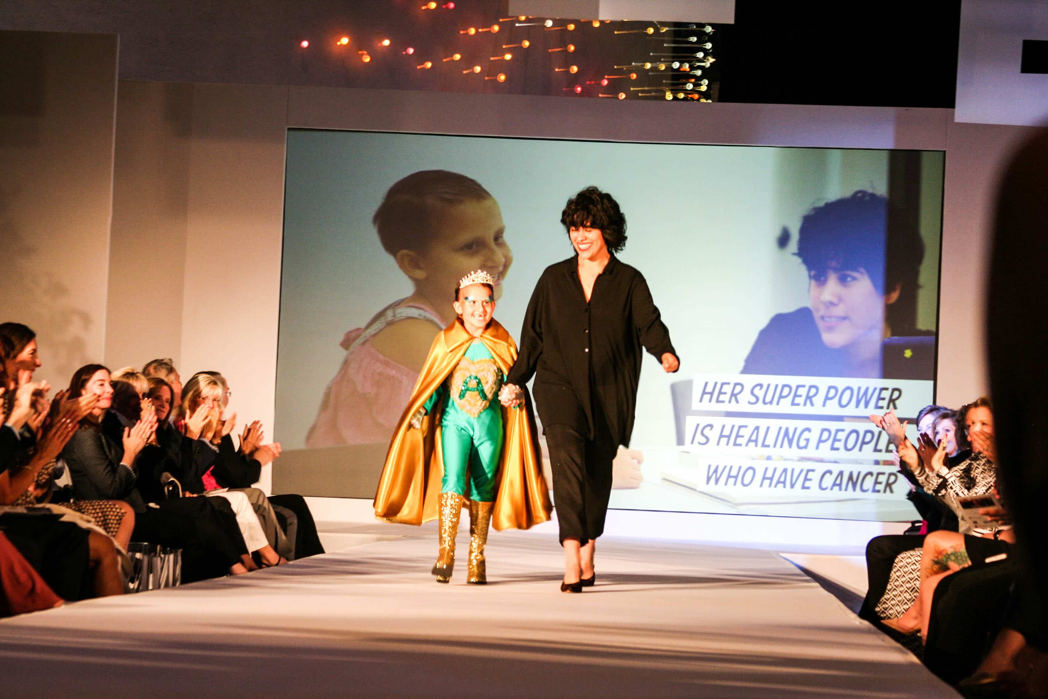 young girl in super hero costume on fashion runway