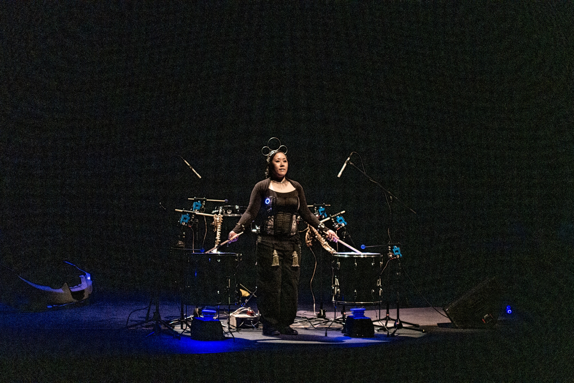 woman performs on drums with digital components