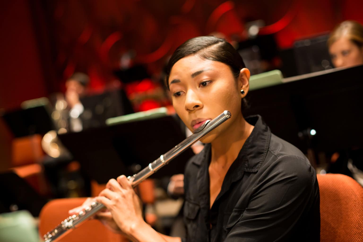 Young woman playing flute in ASU Symphony Orchestra